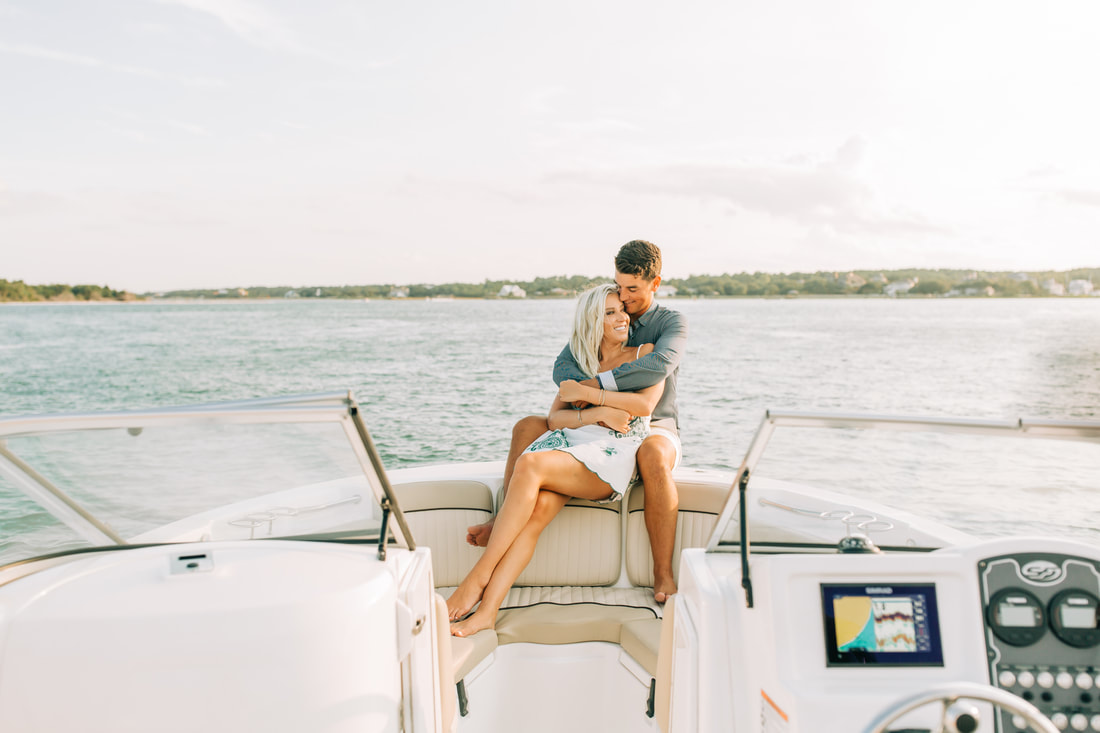 Wilmington wedding photographer takes engagement pictures in Carolina Beach on a boat 
