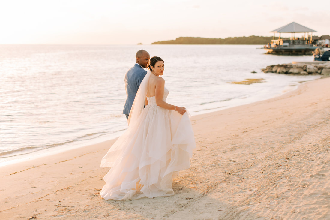 Bride and groom take wedding pictures at Sandals South Coast in Jamaica