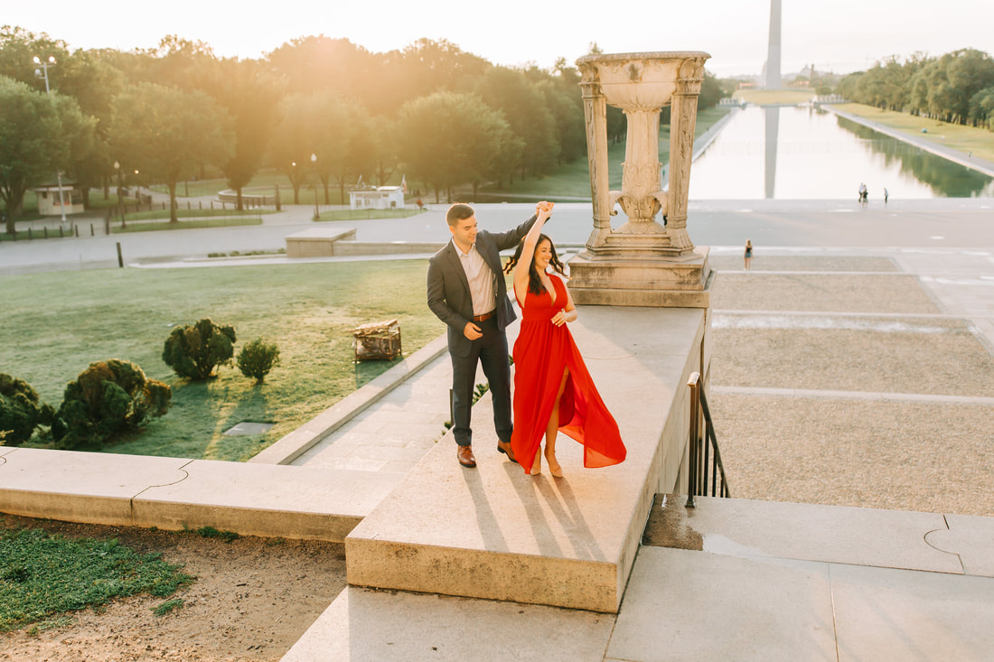 Lincoln Memorial engagement photos at sunrise in Washington DC wedding photographer twirl in red dress